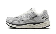 The Nike Zoom Vomero 5 “Chrome” is a mostly grey-based colorway of the retro running shoe.  The Zoom Vomero 5 was first released in 2010 as a performance sneaker before becoming a lifestyle option as part of the Y2K sneaker trend.  On the “Chrome” colorway, the shoe features a Photon Dust mesh construction with grey and Chrome overlays.  A flashy Chrome Swoosh can be found on the sides.  “Nike Vomero 5” branding appears on the tongue.  A Zoom Air cushioning unit within the Sail-colored foam midsole provides all-day comfort. Chrome Shoes, Nike Zoom Vomero 5, Nike Vomero, Retro Running Shoes, Zoom Vomero 5, Vomero 5, Sneaker Trend, Black Converse, Stadium Goods