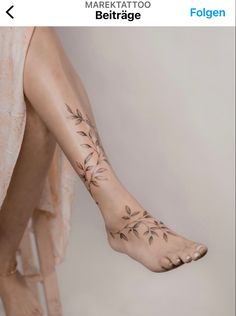 a woman's foot with flowers on it and the bottom part of her leg