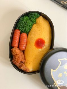 a bento box filled with different types of food on top of a white table