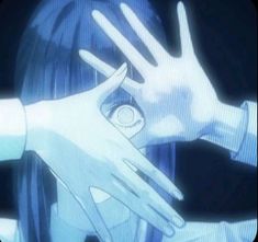 two hands touching each other in front of a tv screen with an anime character on it