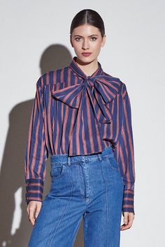 This long-sleeved red and blue-colored striped shirt features wide cuffs and a lace detail that allows endless styling possibilities. The perfect versatile piece to elevate your looks. Made from high-quality materials, this shirt offers both timeless style and durability. With its wide cuffs and lace detail, you can create a variety of looks for any occasion. From casual to formal, this versatile piece is a must-have for any wardrobe. Blue Striped Shirt, Overalls Pants, Wide Cuff, Wide Sleeves, Striped Shirt, Timeless Style, Shades Of Blue, The Label, Lace Detail