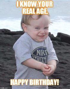 a little boy that is standing in the sand with his hands on his chest and smiling