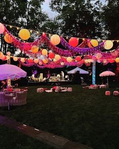 an outdoor party with paper lanterns and umbrellas