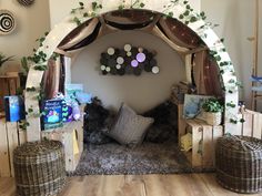 a living room with lots of furniture and decorations on the wall, including a bed