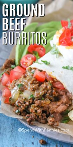 ground beef burritos with tomatoes, green beans and sour cream cheese on top