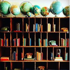 bookshelves with globes and telephones on them