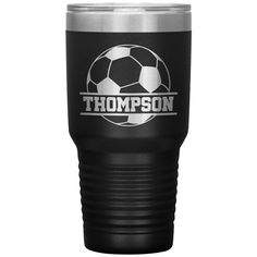 a black and silver tumbler cup with the words,'thomas'on it