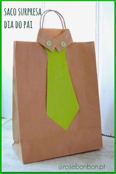 a brown bag with a green tie and buttoned shirt on the front is shown