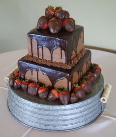 three tiered chocolate cake with strawberries on top