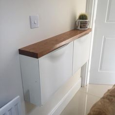 a white cabinet with a wooden top in a room