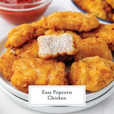 fried chicken on a plate with ketchup and sauce