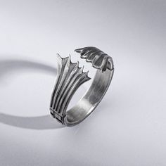 Fly into a fantasy world with the Dragon Wings Men's Ring. This intricately engraved sterling silver ring features exquisite oxidized detailing of a majestic dragon in flight, spreading its wings across the band. The gothic yet refined design makes this ring a unique gift for the daring man with an eye for dark elegance. Slip on this lightweight, comfortable ring daily as a symbol of your man's strength, courage, and free spirit. Whether he's a series fan or loves mystical creatures, this handma Gothic Metal Rings, Fantasy Style Silver Rings Made Of Metal, Gothic Hand Cast Metal Rings, Fantasy Style Silver Metal Rings, Gothic Claw Rings As Gift, Gothic Claw Shaped Metal Rings, Gothic Metal Rings For Collectors, Gothic Collectible Metal Rings, Fantasy Ring