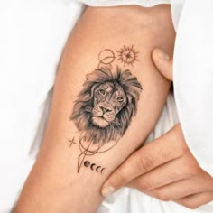 a woman's arm with a lion tattoo on it