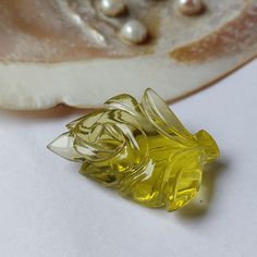 This handcrafted rose leaf carved yellow topaz is a unique 87.90 carat gemstone. The intricate carving makes it a top-quality piece and a special gift for her. Perfect for gifting, this loose fancy yellow topaz adds a touch of elegance to any collection. STONE NAME: Lemon Quartz GRADE: AAA COLOR: Yellow SIZE: 42x32mm SHAPE: Fancy Leaf Carving CARAT WEIGHT: 87.90 CTS CUT: Excellent  CLARITY: VVS/IF NATURAL/LAB-CREATED: Natural  TREATMENT: None MANUFACTURED BY: KRISHNA GEMS, JAIPUR, INDIA IMPORTANT NOTE TO BUYERS: * PRODUCT COLOR MAY SLIGHTLY VARY DUE TO PHOTOGRAPHIC LIGHTINGS OR YOUR MONITOR SETTINGS. WHY CHOOSE KRISHNA GEMS? 1. We Are Manufacturer & Exporter of Gemstone from Jaipur (India), since 2000. Providing affordable & premium quality gemstone that fits every customer. 2. 30 days Mon Intricate Carving, Leaf Carving, Rose Leaf, Gemstone Carving, Fancy Design, Unique Roses, Special Gifts For Her, Rose Leaves, Lemon Quartz