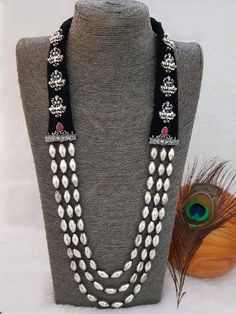 This three-layered Maharashtrian neckpiece, handmade with German silver and coated with silver oxidized plating with beautiful goddess Lakshmi motifs, makes quite an affirmation. This gold-plated silver piece is not so heavy, but it fills your neck with damru shaped beads and adds unmatchable beauty. Pair it with your favourite saree or any Indo- western attires to add a lot of character and elegance to your entire look. As this necklace is handmade, it may have some irregularities or imperfecti Luxury Temple Necklace With Tilla For Navratri, Luxury Temple Necklace For Navratri Celebration, Festival Jewelry With Silver Beads, Traditional Handmade Silver Mala, Silver Cutdana Temple Necklace For Puja, Traditional Tilla Beaded Necklaces For Rituals, Silver Beaded Necklaces For Rituals And Festivals, Chandbali Tilla Beaded Necklaces For Festivals, Navratri Puja Cutdana Mala