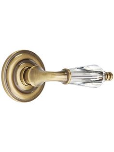 an antique brass door handle with crystal glass knobs