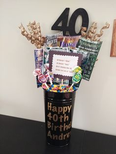 a black vase filled with lots of candy and candies on top of a table