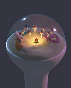 a group of small figurines sitting on top of a white table next to a lit candle