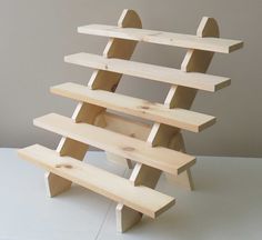 a wooden shelf that has three shelves on it and one is made out of wood