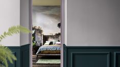 an open door leading to a bedroom with a painting on the wall and a bed