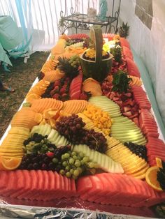 a table topped with lots of different types of fruits and veggies on it