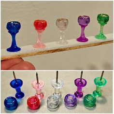 there are many different colored wine goblets on the table