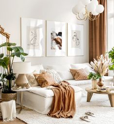 a living room filled with white furniture and lots of plants on top of the couch