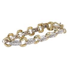 In 14k two-tone gold, this tennis bracelet measures 7 inches in length and boasts a total carat weight of 2.42 carats. Adorned with 55 round brilliant cut diamonds, it features 11 center diamonds weighing 0.06 carats each, along with 22 accent diamonds at 0.05 carats each, and 22 more at 0.03 carats each. With a width of 9.75mm, it exudes elegance and sophistication. The diamonds, with a clarity of I1 and a color of G-H, ensure a dazzling sparkle. Secured with a tennis clasp and weighing 16.8 gr Anniversary Diamond Bracelet With Solid Link Construction, Diamond Tennis Bracelet With Oval Link And Accents, Oval Link Diamond Tennis Bracelet With Diamond Accents, Oval Link Diamond Tennis Bracelet With Accents, Ring Bracelet Chain, Safety Chain, Tennis Bracelet Diamond, Tennis Bracelet, Round Brilliant Cut Diamond