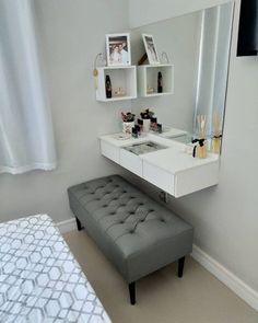 a bedroom with a bed, vanity and mirror