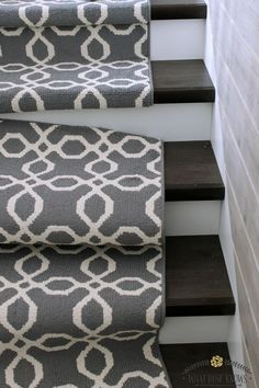 the stairs are decorated with black and white rugs, which have been placed on top of each other