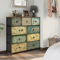 a multicolored dresser in a bedroom with a mirror on the wall above it