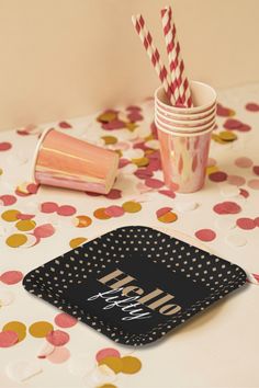 a table topped with paper plates and cups