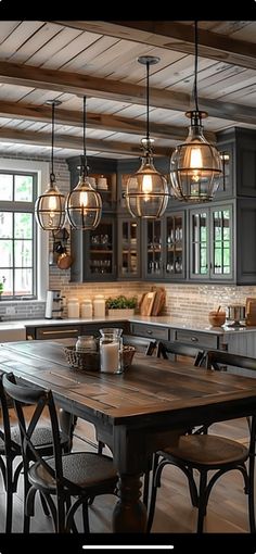 a kitchen with wooden floors and lots of lights hanging from the ceiling over the island