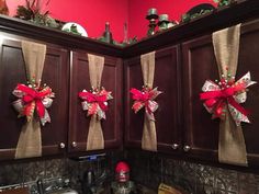 the kitchen cabinets are decorated with red bows