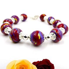 Harmoniously uniting the timeless elegance of flowers with contemporary design, our Harmony Bracelet is a truly unique piece of keepsake jewelry. This exquisite bracelet features 6 to 10 individually handcrafted flower infused beads, each holding your precious flower petals. Complimented by detailed sterling silver caps and interspersed silver beads, it's a blend of beauty and sentimental value. All components used in the earrings are crafted from sterling silver, ensuring a timeless and high-qu Adjustable Large Bead Sterling Silver Jewelry, Adjustable Large Beads Sterling Silver Jewelry, Adjustable Large Beaded Sterling Silver Jewelry, Elegant Multicolor Sterling Silver Beaded Bracelets, Silver Flower Jewelry With Spacer Beads, Flower Shaped Large Beads Jewelry Gift, Silver Bracelets With Large Beads For Gift, Sterling Silver Jewelry With Large Beads For Gift, Contemporary Bracelets