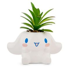 a small white planter with a green plant in it's head and eyes