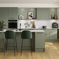 two green bar stools are in front of the kitchen counter