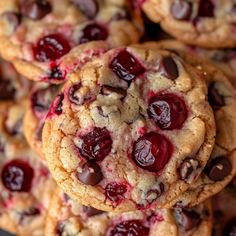 chocolate chip cookies with cherries are stacked on top of each other in a pile