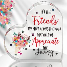 a heart shaped plaque with flowers and butterflies on it that says, it's the friends we meet along the way that help us appreciate the journey