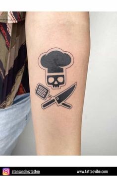 a tattoo with a chef's hat, knife and skull on the left arm