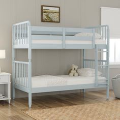 a blue bunk bed sitting on top of a hard wood floor next to a white dresser