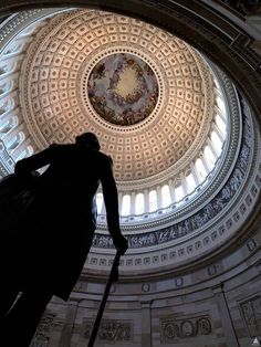 the inside of a domed building with a statue in it's center and a dome ceiling