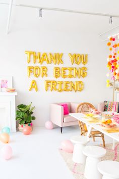 a white room with balloons and decorations on the walls, along with a sign that says thank you for being a friend