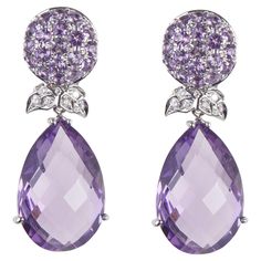 18 Karat WG Diamond and Amethyst Earings 12 Diamonds 0.16 Carat 38 Amethist 2.15Carat 2 Amethyst 29.46 Carat Founded in 1974, Gianni Lazzaro is a family-owned jewelery company based out of Düsseldorf, Germany. Although rooted in Germany, Gianni Lazzaro's style and design is more reminiscent of Italian luxury and craftsmanship. The exquisite pieces and opulent gemstones embody the sunny Italian coast. Mixtures of bright gemstones and impeccable diamonds define this exuberant brand. "To Embody the Luxury Purple Diamond-cut Jewelry, Luxury Purple Earrings With Gemstone Accents, Luxury Faceted Purple Earrings, Exquisite Multi-stone Amethyst Jewelry, Luxury Purple Multi-stone Earrings, Italian Coast, Dusseldorf, Amethyst Earrings, Italian Luxury