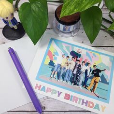 a birthday card sitting on top of a table next to a pen