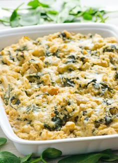 a casserole dish filled with spinach and cheese