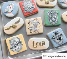 decorated cookies in the shape of hogwart's houses and crests on display