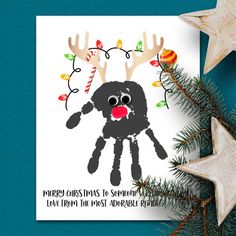 a christmas card with reindeer's handprint on it