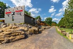 there is a large rock lined road in front of the building that has a restaurant on it