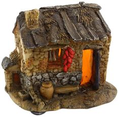 a figurine of a stone house with red decorations